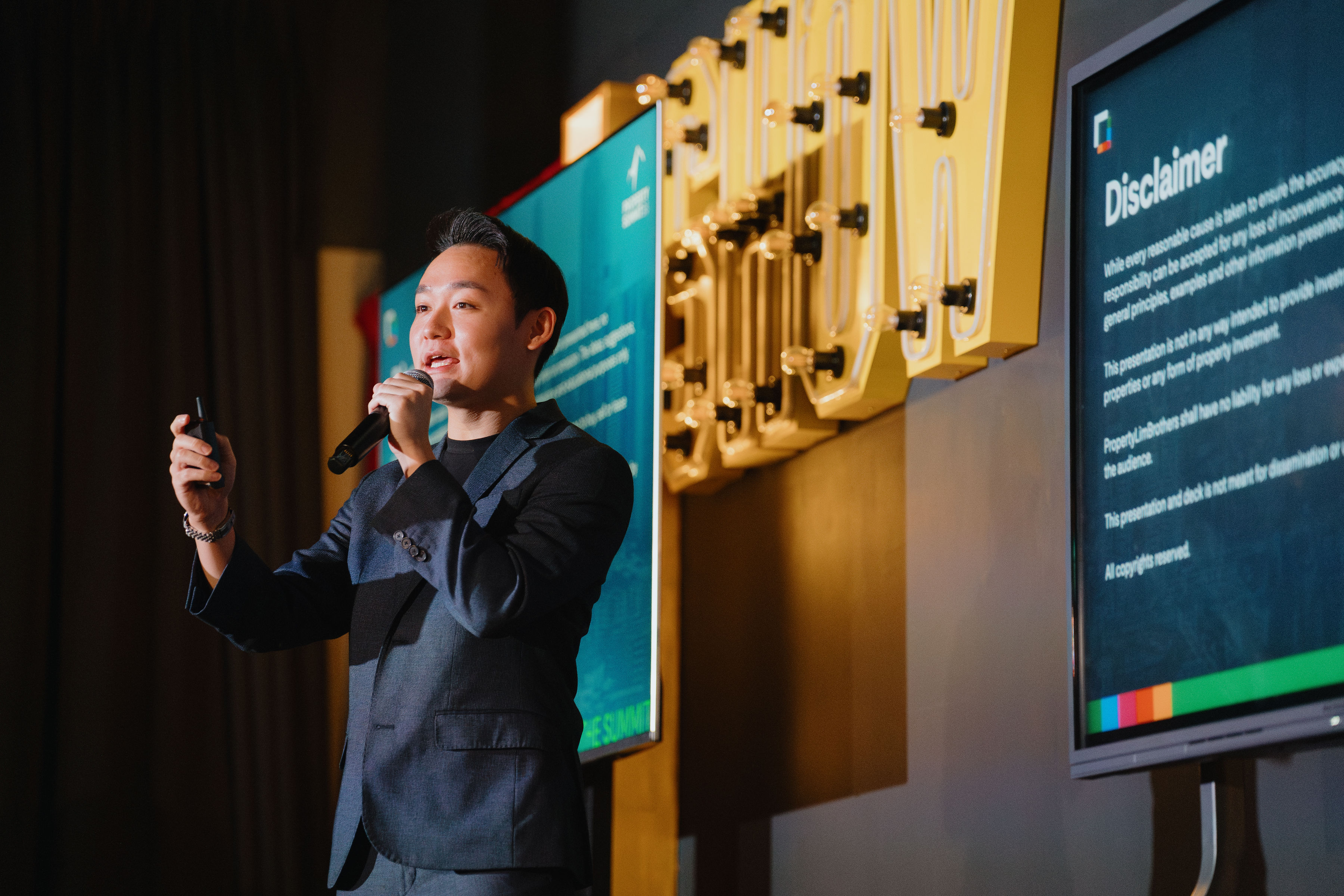 Jun Wei presenting on stage at Property Summit 2024
