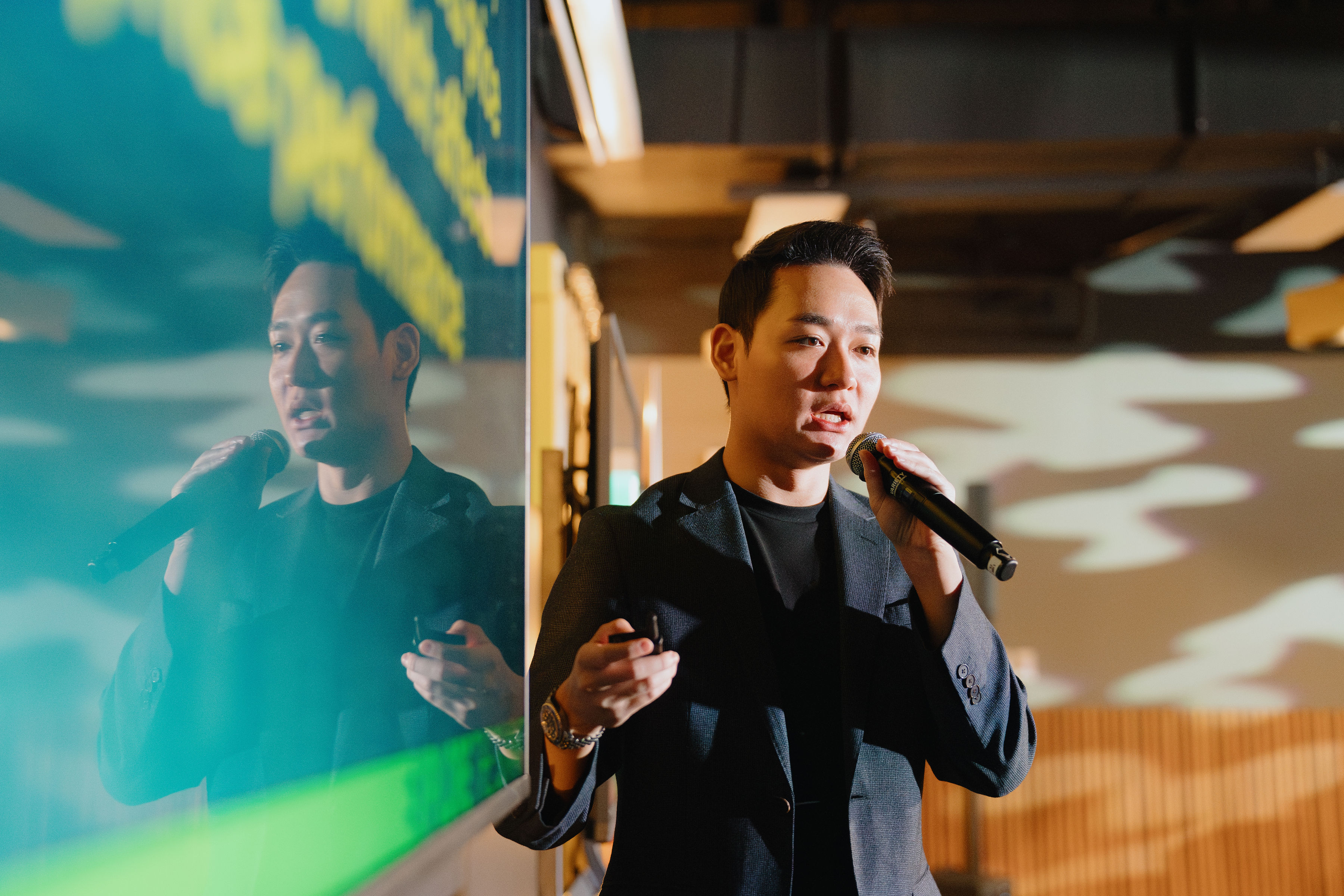 Jun Wei presenting with screen reflection at Property Summit 2024